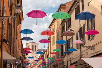 Fototapeta na wymiar Ancient medieval street in the downtown of Ferrara city with umb