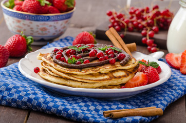 Cinnamon pancakes with chocolate sauce and berries