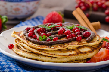 Cinnamon pancakes with chocolate sauce and berries