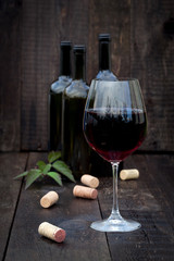 Glass of red wine on old wooden table