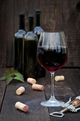 Glass of red wine on old wooden table