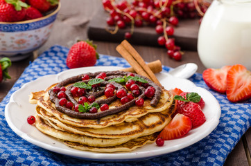 Cinnamon pancakes with chocolate sauce and berries