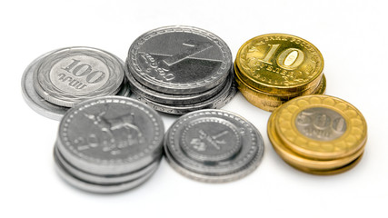 Stacks of Russian, Georgian and Armenian coins on a white background
