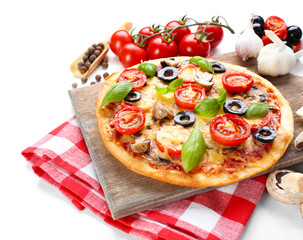 Tasty pizza with vegetables and basil on cutting board isolated on white
