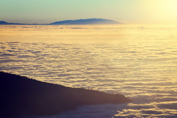 Aerial view over clouds above ocean water with last sunshine, Tenerife, Canary Islands, Spain