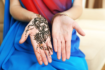 Image of henna on female hands, closeup
