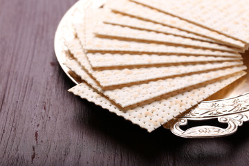 Matzo for Passover on metal tray on table close up