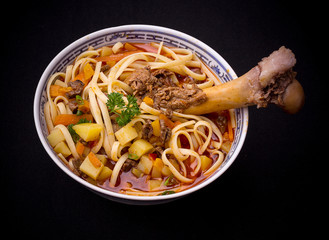 Noodle soup Lagman, large bone, top view
