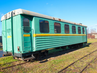 Fototapeta na wymiar Green narrow-gauge railway wagon