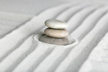 Fototapeta na wymiar Zen garden with stones on sand background