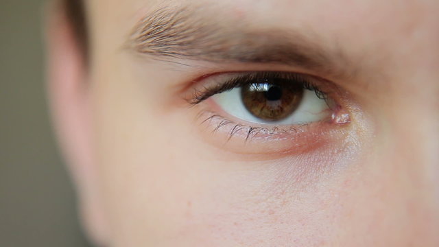 Attractive Young Man Looks Into The Camera then closes his eyes