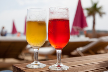 Two glasses of cold beer in the beach bar