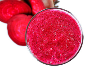 Glass of beet juice with vegetables isolated on white