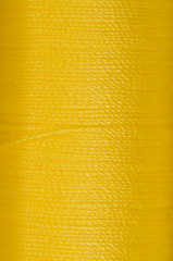 bobbin of yellow thread