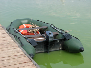Inflatable motor boat near the pier