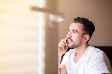 Obraz premium Young attractive man in morning sunshine