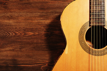 Acoustic guitar on wooden background