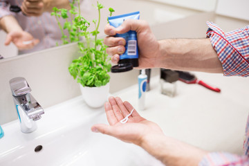 Man pouring hair paste on hand