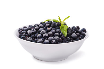 Plate with frozen blueberries on a white background