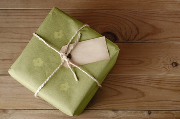 String Tied Parcel with Label and Green Floral Wrapping Paper