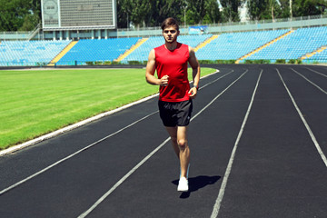 Young man jogging on stadium