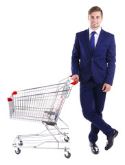 Young man with empty shopping cart, isolated on white