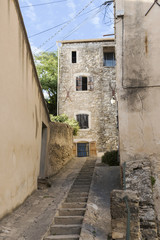 narrow street with staircase in an old village in southern Europ