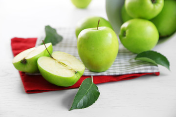 Green apples on table with napkins, closeup