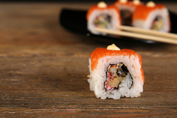 Rolls with sticks on wooden table close up