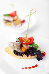 Tasty canapes on wooden table, close up