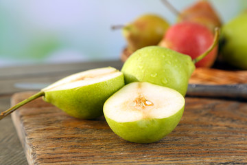 Ripe tasty pears on bright background