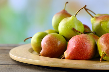 Ripe tasty pears on bright background