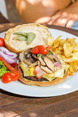 Woman eating a cheese burger at the summer lounge