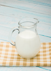jug of milk on a yellow checkered tablecloth