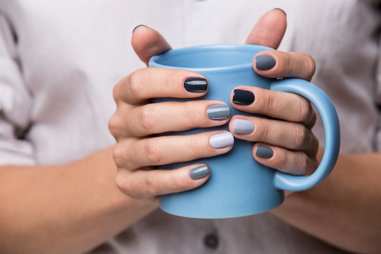 Female hands with blue cup