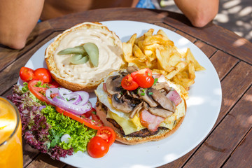 Woman eating a cheese burger at the summer lounge