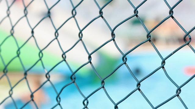 blurry water park behind a fence