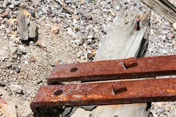 Rusty metal and broken weathered wood at an abandoned mine