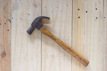 Hammer on wood background