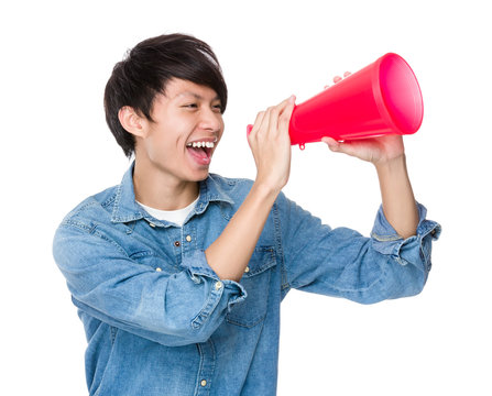 Asian young man shout with megaphone