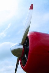 Airplane propeller side view with sky in background on a sunny day.
