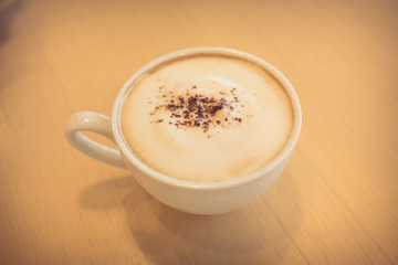 hot coffee on wooden table in the cafe