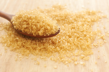 Sugar in a wooden spoon, Selective focus