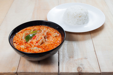 Tom Yum soup with Jasmine Rice on wooden table,thai food