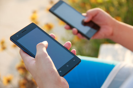 Two People Holding Smart Mobile Internet