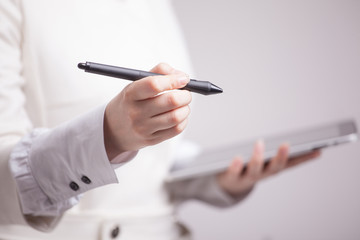 woman holding a tablet and stylus