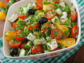 Greek salad with fresh vegetables, feta cheese and black olives