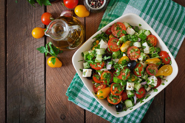 Greek salad with fresh vegetables, feta cheese and black olives