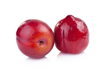 Obraz premium red plums isolated on white