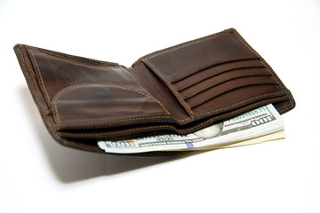 Old wallet with banknotes of US dollars inside